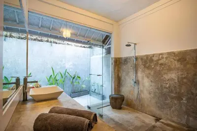a bathroom with a tub and a sink and a shower at Villa Dolcevita Seminyak in Seminyak