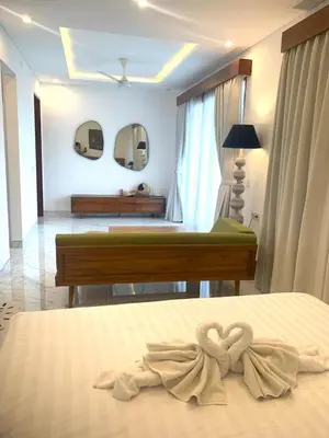 a bedroom with a bed with a bow on it at Capung Smart Residence in Sanur