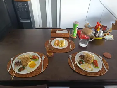 two plates of breakfast food on a table at Capung Smart Residence in Sanur