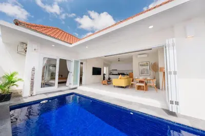 a villa with a swimming pool and a living room at The Eclipse Villas - The Luxurious 2BR Private Pool Canggu Getaway in Canggu
