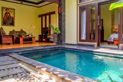a swimming pool in the middle of a house at Swaran 1 BR Private Pool Villa in Seminyak