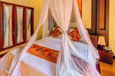 a bedroom with a bed with a mosquito net at Bramanty 2 BR Private Pool Villa in Seminyak