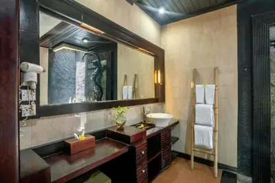 a bathroom with a sink and a mirror at Catra 3 BR Private Pool Villa in Seminyak