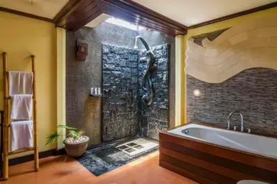 a bathroom with a large tub and a shower at Catra 3 BR Private Pool Villa in Seminyak