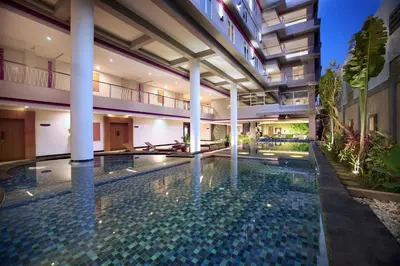 a swimming pool in the middle of a building at favehotel Sunset Seminyak in Seminyak