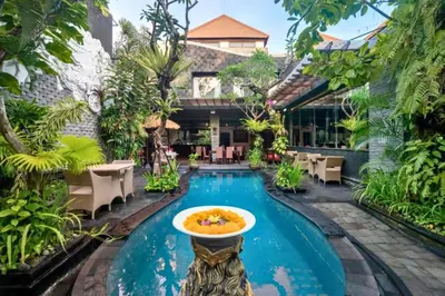 a pool at a resort with a bowl in the middle at Kastara 4 BR Private Pool Villa in Seminyak