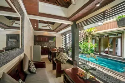 a living room with a swimming pool in a house at Kastara 4 BR Private Pool Villa in Seminyak