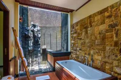 a bathroom with a large window and a bath tub at Kastara 4 BR Private Pool Villa in Seminyak