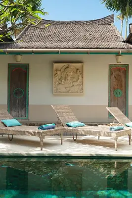 a resort with two chairs and a swimming pool at Villa Anais Seminyak in Seminyak