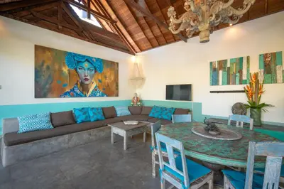 a living room with a couch and a table at Villa Anais Seminyak in Seminyak