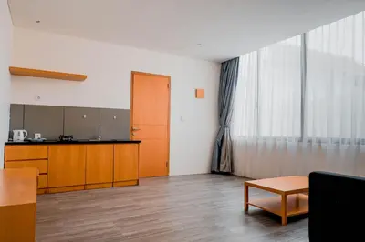 an empty room with a kitchen and a table at Sunrise Suite Seminyak by ARM Hospitality in Kerobokan