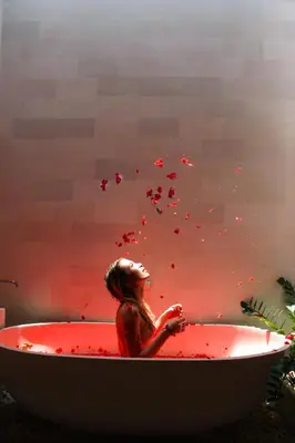 a woman in a bath tub filled with red blood at Villa Angela in Seminyak