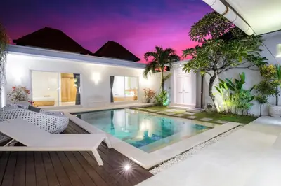 a villa with a swimming pool and a house at Villa Angela in Seminyak