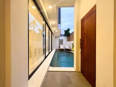 a hallway with a swimming pool in a house at Villa Prada II 3BR Villa Near to Beach in Seminyak in Seminyak