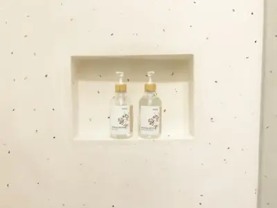 two bottles in a white niche in a white wall at Villa Prada II 3BR Villa Near to Beach in Seminyak in Seminyak