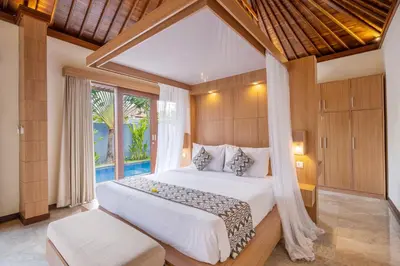 a bedroom with a bed and a large window at Kings Villas Sanur by Moria in Denpasar