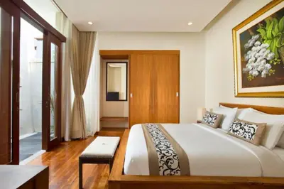 a bedroom with a large bed in a room at Vadjar 1 BR Private Pool Villa in Seminyak
