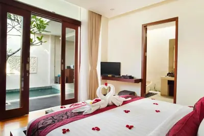 a bedroom with a bed with two swans on it at Vadjar 1 BR Private Pool Villa in Seminyak