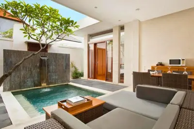 a swimming pool in a living room with a couch at Zefanya 2 BR Private Pool Villa in Seminyak