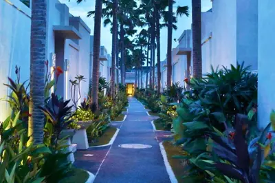 a walkway with palm trees and plants on a street at Zefanya 2 BR Private Pool Villa in Seminyak
