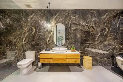 a bathroom with a toilet sink and a mirror at The Continental Modern Luxury 4 BR Villa in Seminyak Central in Seminyak