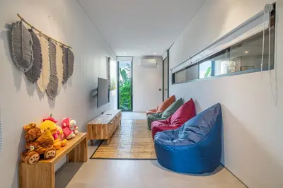 a living room with two chairs and a table at The Continental Modern Luxury 4 BR Villa in Seminyak Central in Seminyak