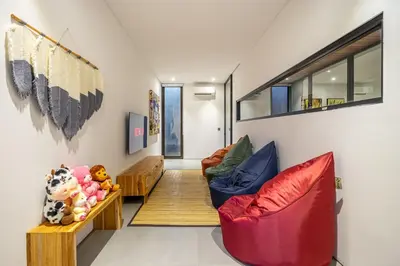 a living room with two chairs and a couch at The Continental Modern Luxury 4 BR Villa in Seminyak Central in Seminyak