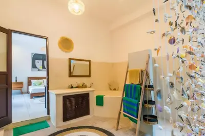 a bathroom with a tub and a sink and a mirror at Taman pangeran villa in Seminyak, 2BR large pool, Prime Location ! in Seminyak