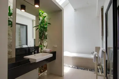 a bathroom with a sink and a bath tub at Anakula 1 - Modern 2 BR Villa, Seminyak in Seminyak