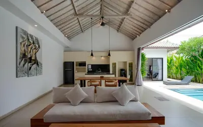 an open living room with a couch and a dining table at Anakula 1 - Modern 2 BR Villa, Seminyak in Seminyak