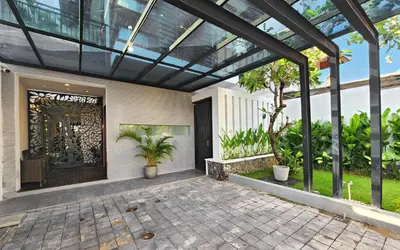 a pergola over a front door of a house at Villa Rumpi Seminyak by Nagisa Bali in Legian