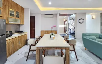 a kitchen and dining room with a table and chairs at Villa Rumpi Seminyak by Nagisa Bali in Legian