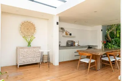 a kitchen and dining room with a table and chairs at Stylish Tropical Villa 2 Br , Canggu , 400m To Finn Beach in Canggu