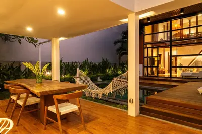 a porch with a hammock and a house at Stylish Tropical Villa 2 Br , Canggu , 400m To Finn Beach in Canggu