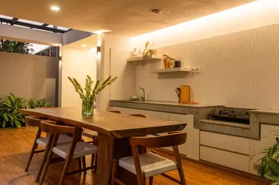 a kitchen with a wooden table and chairs at Stylish Tropical Villa 2 Br , Canggu , 400m To Finn Beach in Canggu