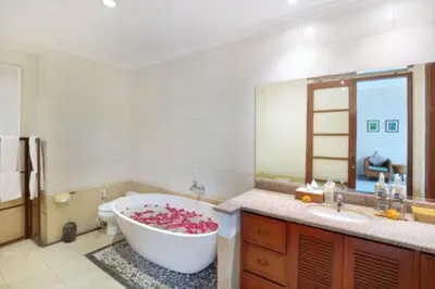 a bathroom with a tub and a toilet and a sink at Luxury 3BR Private Pool Villa in Seminyak