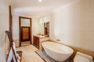 a bathroom with a large tub and a sink at Luxury 3BR Private Pool Villa in Seminyak