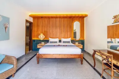 a bedroom with a bed with a wooden headboard at Luxury 3BR Private Pool Villa in Seminyak