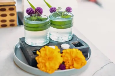a plate of food with two glasses of water and flowers at Beautiful 1BR Private Pool Villa in Seminyak