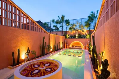 a swimming pool with a pizza on the side of a building at Modern 1BR Private Pool Villa With Bathtub in Seminyak