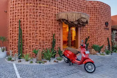 a red scooter parked in front of a building at Modern 1BR Private Pool Villa With Bathtub in Seminyak
