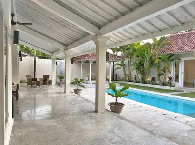 an outdoor patio with a pool and a house at Fully renovated villa 3BR in Seminyak - Oberoi in Seminyak