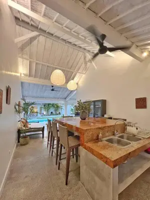 a kitchen with a sink and a table with chairs at Fully renovated villa 3BR in Seminyak - Oberoi in Seminyak