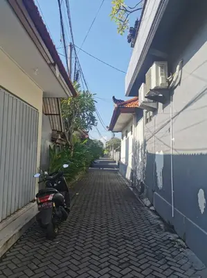 a motorcycle parked on a brick alley between two buildings at Fully renovated villa 3BR in Seminyak - Oberoi in Seminyak