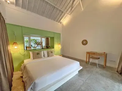 a bedroom with a white bed and a green wall at Fully renovated villa 3BR in Seminyak - Oberoi in Seminyak