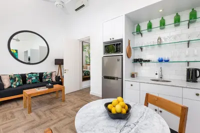 a kitchen and a living room with a table at Villa Jabula in Seminyak