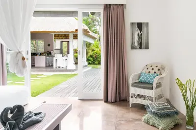 a living room with a door open to a patio at Villa Bliss a Paradise of Three Independent Villas in Canggu