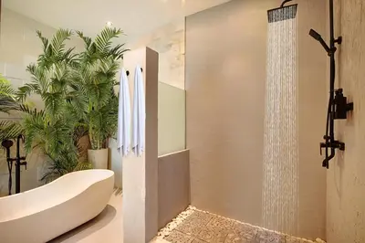 a bathroom with a white tub and a shower at ATLAS BEACH FEST CHILL 6bed VILLA LOVED by BiG GROUPS EASY Walk to Beach in Canggu