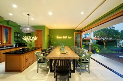 a large kitchen with a wooden table and chairs at ATLAS BEACH FEST CHILL 6bed VILLA LOVED by BiG GROUPS EASY Walk to Beach in Canggu