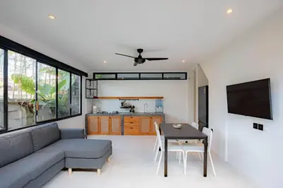 a living room with a couch and a table at The Drupadi Apartments Town House LOLA in Seminyak